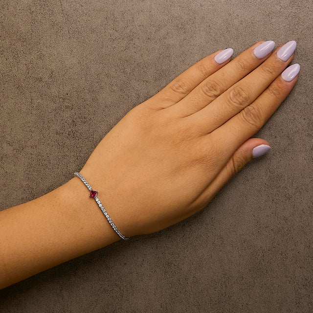 Embody elegance with this enchanting .925 sterling silver tennis bracelet, rhodium-plated for an everlasting gleam and...