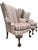 A refined pair of Queen Anne style wingback lounge chairs by Southwood, dated 1993, distinguished by elegantly carved...