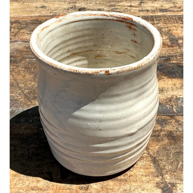 This vintage studio pottery vase is a masterclass in Organic Modernism, showcasing the beauty of handcrafted...