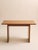 A beautifully minimal mid-century modern console table in warm teak, defined by its clean architectural lines and softly...