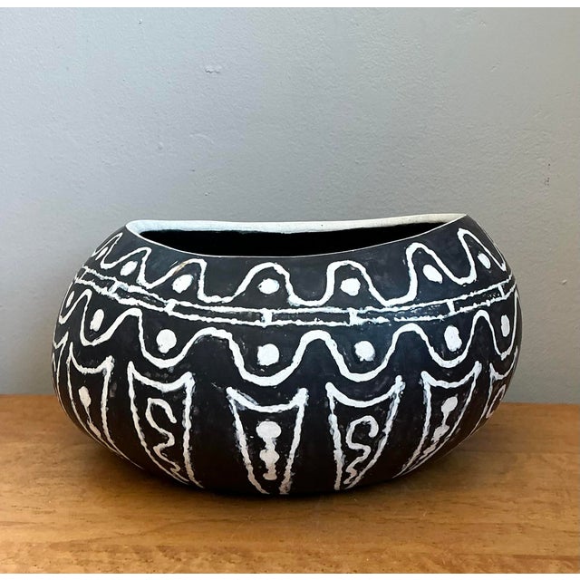 This striking studio pottery vessel makes a bold statement with its substantial scale and primitive, tribal-inspired...