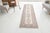 This is a vintage Turkish Oushak rug from the Mid 20th Century. The piece was hand-knotted.