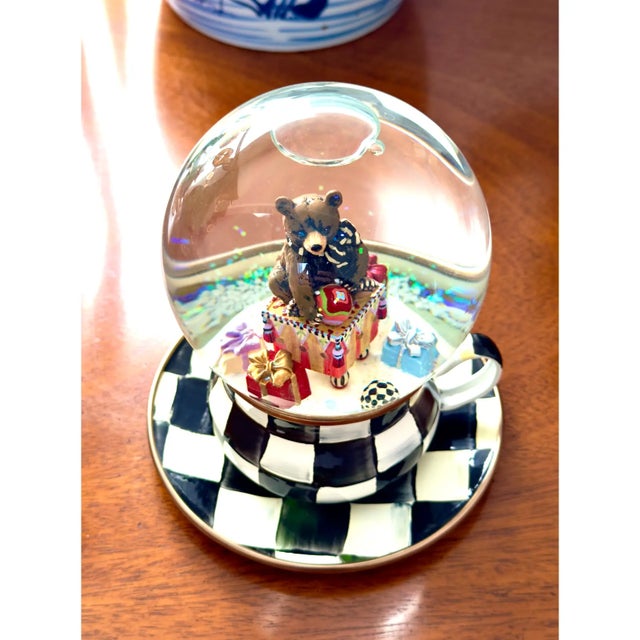 This is a vintage Mackenzie-Childs Christmas Holiday Snow Globe, it depicts a teddy bear with presents and sits upon a...