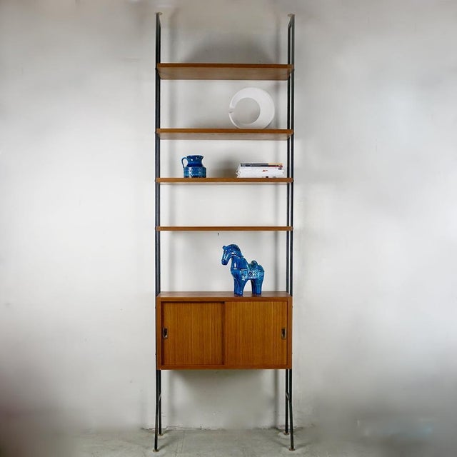 A beautiful rare and substantial Italian midcentury Floor to Ceiling veneered wood bookcase or modular wall unit. It...