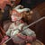 This artwork features a whimsical scene with a clown fish character, adorned in playful attire, riding atop a larger fish,...