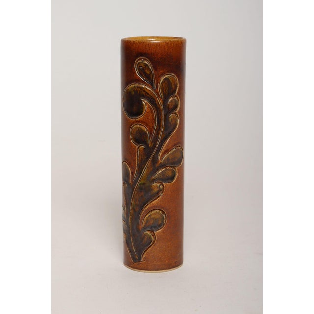 Studio pottery vase embellished on two sides (ca. 1960s, USA). Slim, cylindrical form with exterior matte glazes of amber...
