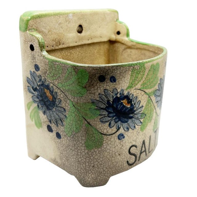 A mid-century ceramic hanging salt cellar with a floral motif. This fun salt vessel will be a great conversation piece in...