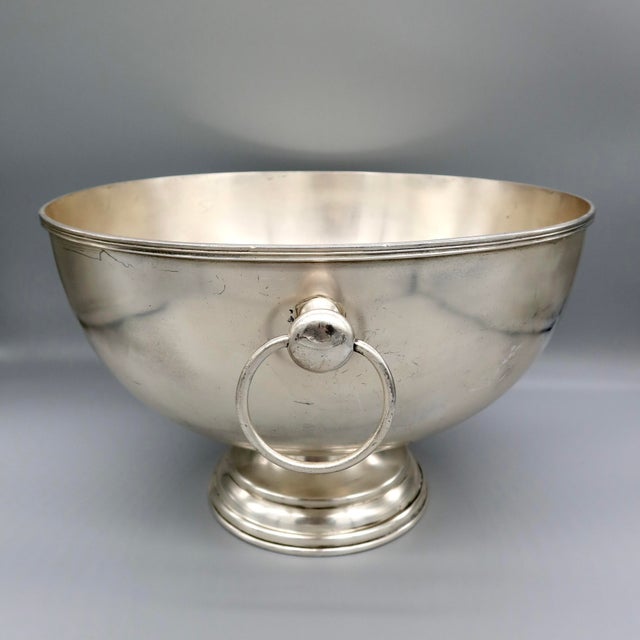A vintage silverplate champagne bath (also suited as a punch bowl), standing on a footed pedestal base with dual ring...