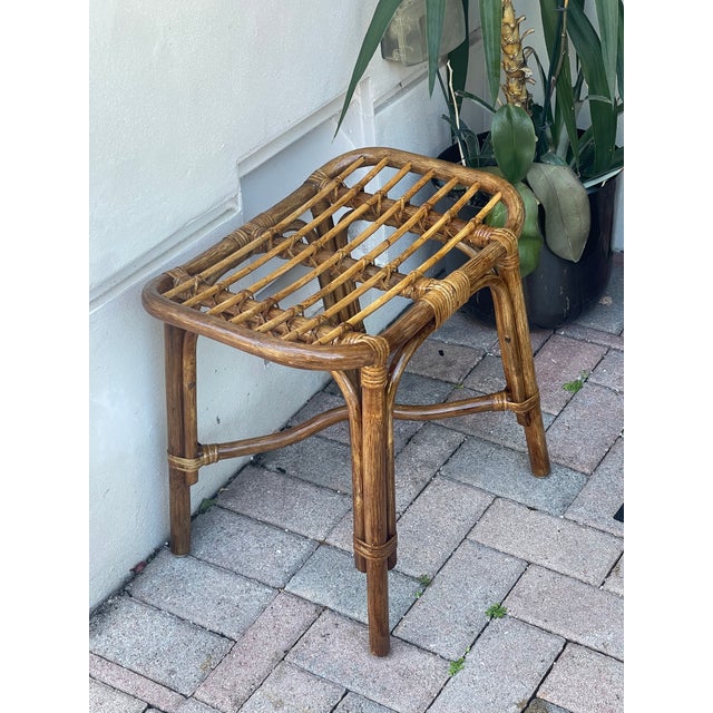 Mid century modern bamboo rattan footstool with strawberry upholstered cushion.