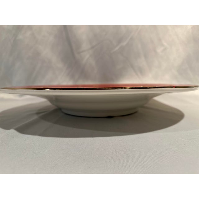 A vintage Starburst design large scale serving bowl with a red background and 18k gold trim starburst pattern. 18.25”...