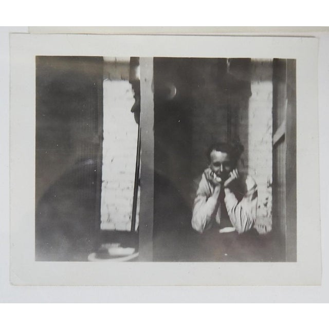 Mid 20th Century vernacular snapshot photograph of man looking out of a window. Unframed.