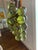 Fabulous bunch of translucent green lucite grapes securely attached to a wood stem. Balls are approximately 2” and appear...