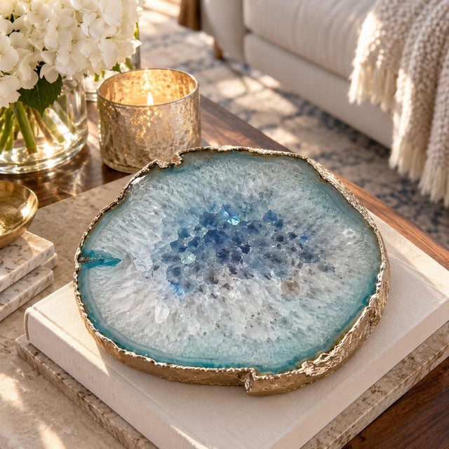 Beautiful natural blue agate geode slab featuring sparkling quartz crystals, icy blue and white tones, and elegant gold...