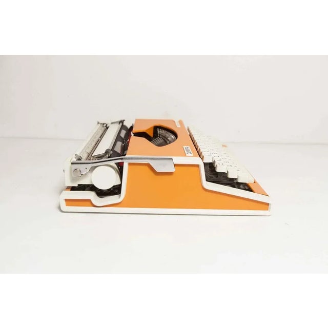 Olympia brand typewriter Model Luxury Traveler Model, it is absolutely superb with its original orange color and white...