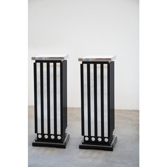 Elegant and essential , lacquered wood structure, glossy black with 2 glass shelves and upper farm in carrara marble basic...