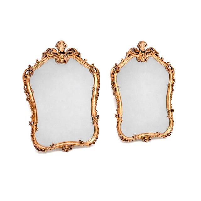 A stunning pair of antique French Rococo style gilt wood mirrors. They are in the classical Rococo style, they were made...