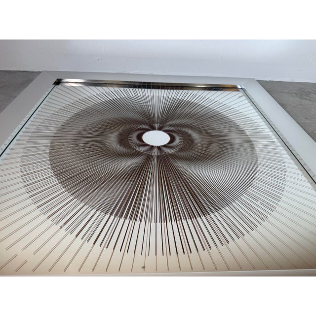 A striking 1970s vintage Op Art wall sculpture featuring a mesmerizing sunburst design on glass, creating a captivating...