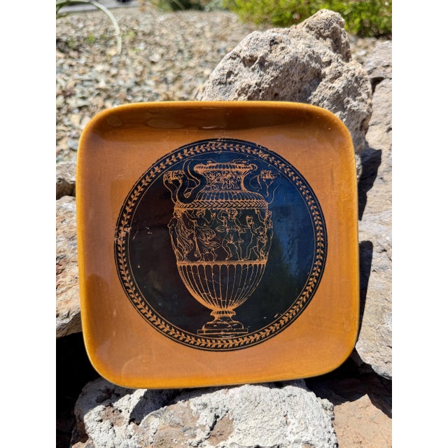 Designed by Italian artist Piero Fornasetti in the early 1950s, this authentic mid-century porcelain square plate was...