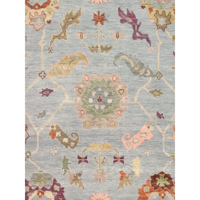 Expertly hand-knotted from fine wool, this Turkish Oushak rug showcases the collection's signature large-scale semi-...