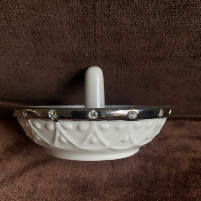 Ring holder crafted of Lenox white porcelain, accented with platinum and sparkling crystals. Beautiful!