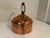 Offering an Antique Large Copper Tea Kettle w/ a Swinging Turned Wood Handle. The kettle measures approximately 9" in...