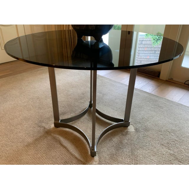 Modern dining table with aluminum base. 1/2" thick round smoky glass top. Purchased from H.D. Buttercup in Los Angeles.