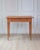 A charming mid-19th-century Swedish side table handcrafted in pine, featuring a clean rectangular top above a single...