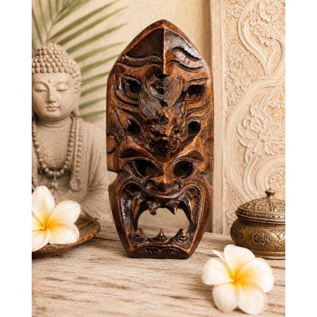 A wonderfully dimensional vintage Balinese wood carving combining a fierce open-mouthed demon or guardian face with a...