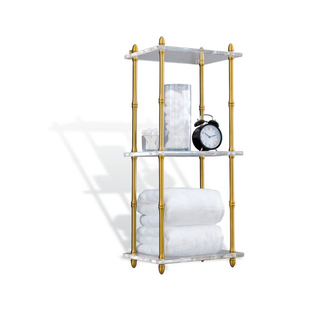 In the Hollywood Regency style, our Carmel shelf features polished brass plated bamboo shaped turnings and three sleek...