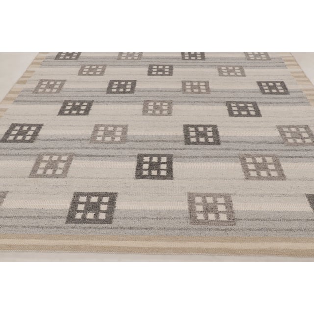 Handwoven in wool and natural yarns, this new 9x12 Scandinavian rug showcases an understated geometric layout with...