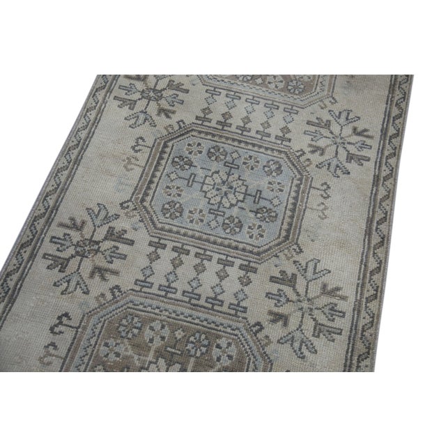 Introducing a one-of-a-kind vintage Turkish hand-knotted wool rug, carefully crafted by skilled artisans using traditional...