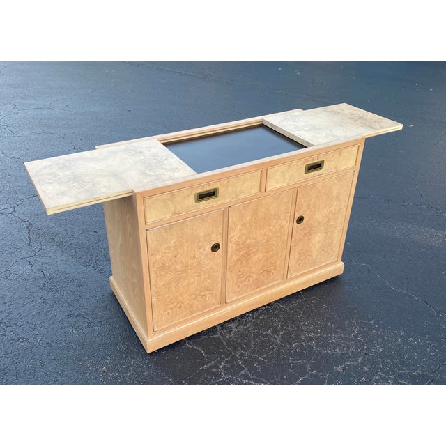 This elegant Drexel Heritage server buffet is crafted from luxurious olive ash burl veneer, showcasing a striking,...