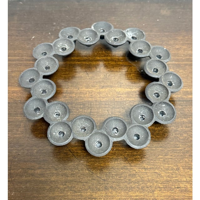 Dansk round cast iron candle stick holder, can hold up to 24 thin tapered candles. The candle holder is stamped on the...