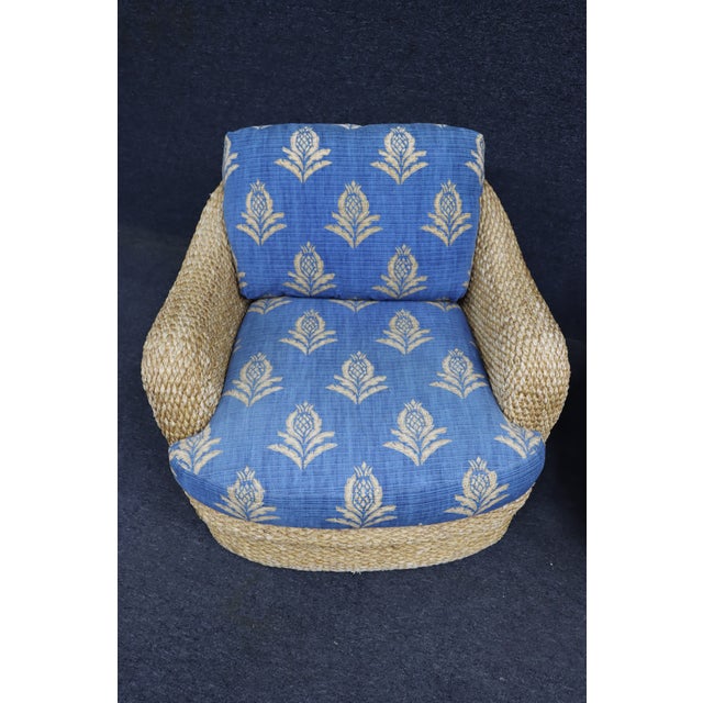 Pair of custom wicker swivel lounge chairs attributed to Century Furniture, dating to the 1980s. Each chair features a...