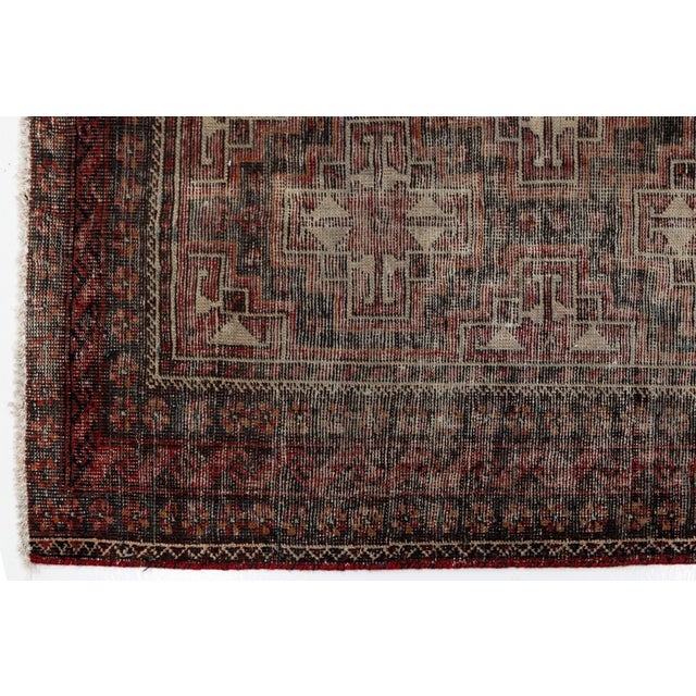This exquisite antique hand-knotted wool rug showcases striking Caucasian-inspired geometric medallions rendered in a...