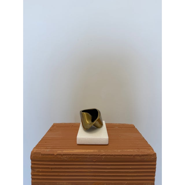 Abstract patinated bronze sculpture by unknown Brazilian artist on a white stone base circa 1990s. Piece has a signature,...