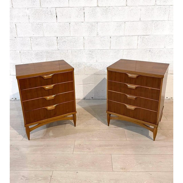 Pair of walnut chests of drawers, each with four spacious drawers. Made by La Permanente Mobili Cantù, the brand is...