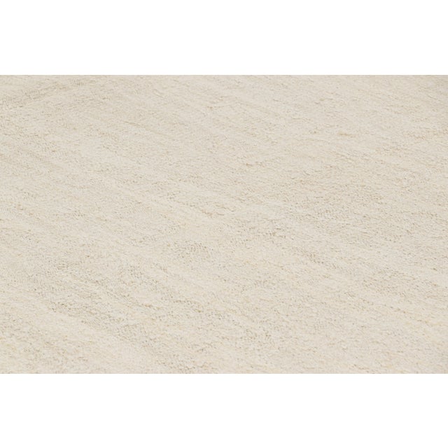 Handwoven in wool, circa 1950-1960, this 9x14 vintage kilim is among a special new curation of simple, near monochromatic...