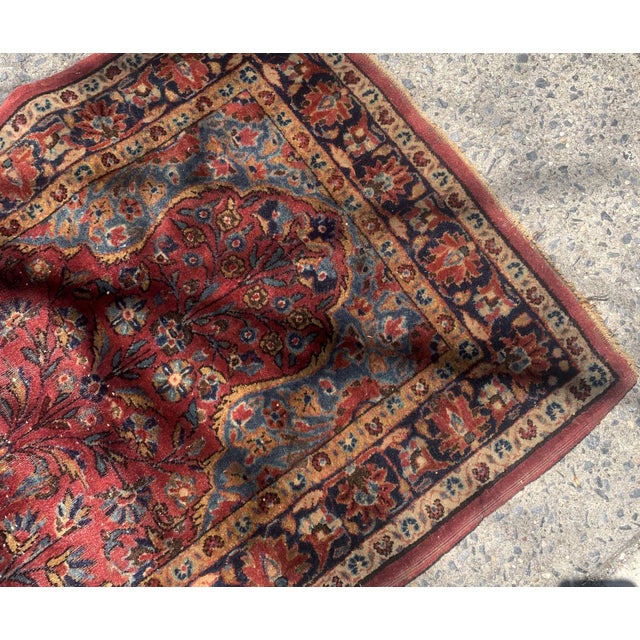Handmade antique Persian Sarouk rug in red color. The rug is from the beginning of 20th century in original condition, it...