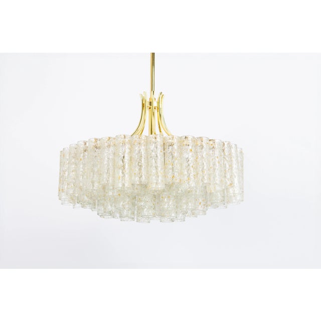 Fantastic four-tier mid-century chandelier by doria, germany, manufactured circa 1960-1969. Four rings of murano glass...