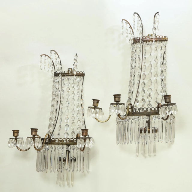 The metal frame hung with crystal drops and pendants. Each with three candlearms. Not electrified. From the Collection of...