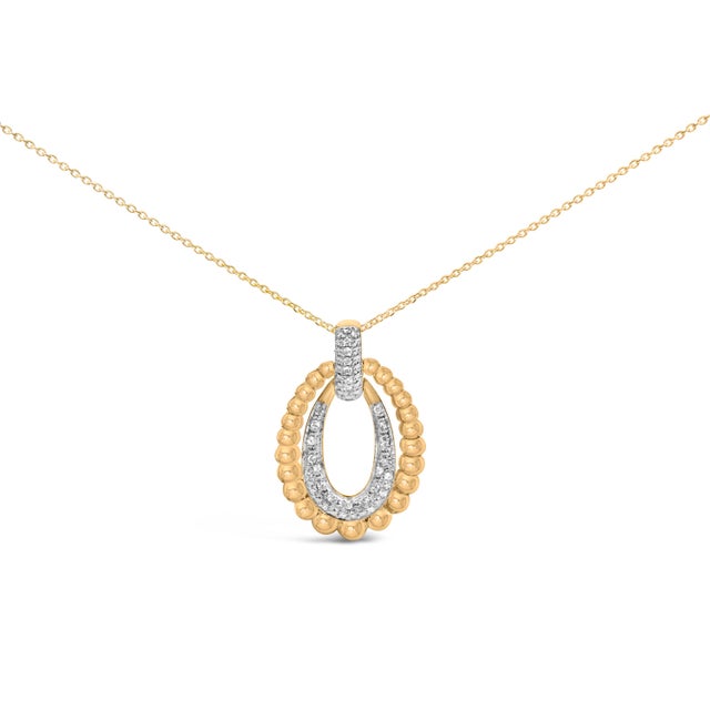 A luminous study in contrasts, this pendant frames your heartbeat with two open ovals—an inner halo flaring with pavé...