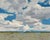 "Under Open Skies" is an oil on mounted linen landscape painting by Michael Magrin, completed in 2025. Cumulus clouds fill...