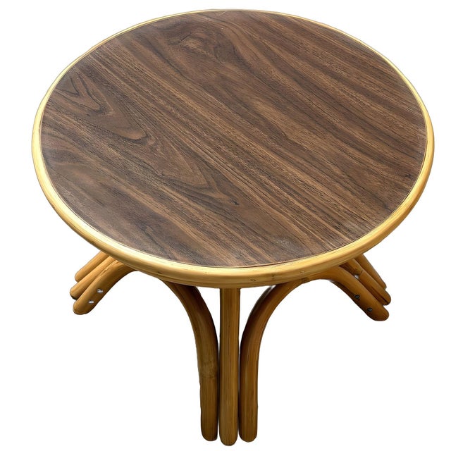 Restored round rattan coffee table, featuring wood grain Formica top and arched rattan base. This charming piece combines...