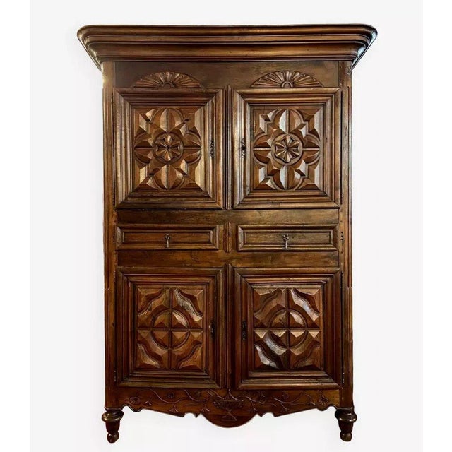 Four-door cabinet, 18th century, in solid walnut. front opening with four doors decorated with raised rosettes surmounted...