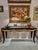 A beautiful French style dark brown wood console table, with carved gold gilt draped valance detail along front and sides....
