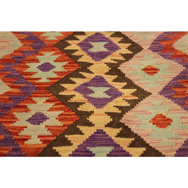 Add a touch of elegance to your home with this casual chic hand woven Tribal Kilim wool rug. Constructed on a loom by...