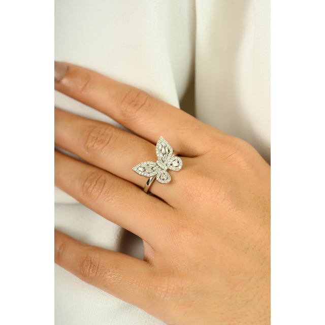 Graceful and enchanting, this 14K white gold ring features an elegant butterfly motif crafted from a dazzling array of...