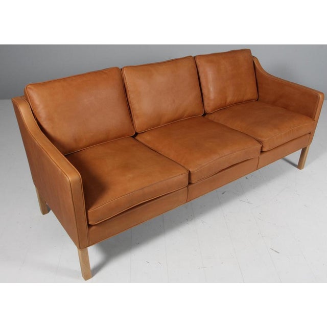 Børge Mogensen three-seat sofa new upholstered with vintage full grain aniline leather. Legs of soap treated oak. Model...
