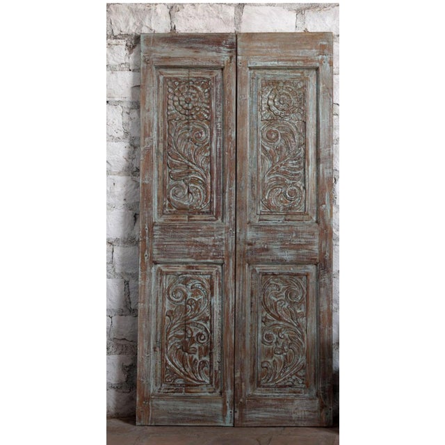 Infuse your space with artistic charm and vintage elegance with this antique artisan-carved double door, finished in a...